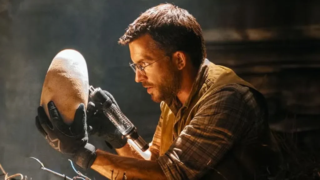 Jonathan Bailey com um ovo de dinossauro em Jurassic World Recomeço