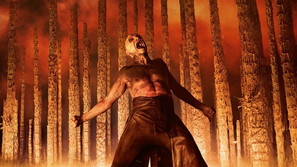 Ralph Fiennes em cenário em chamas de Extermínio O Templo dos Ossos